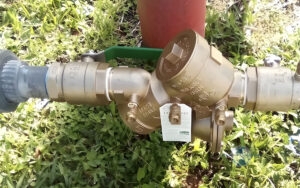 certified plumber performing backflow prevention device testing and installation