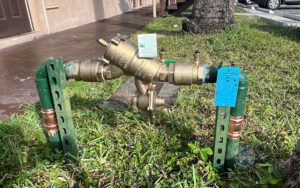 technician inspecting a backflow prevention device for leaks and corrosion