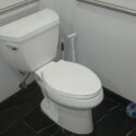 Toilet in an accessible restroom serviced by Atlas Plumbing of Hollywood